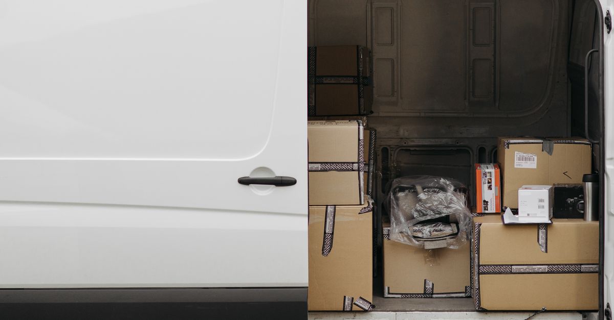 Open delivery van filled with boxes, ready for logistics and transport services.